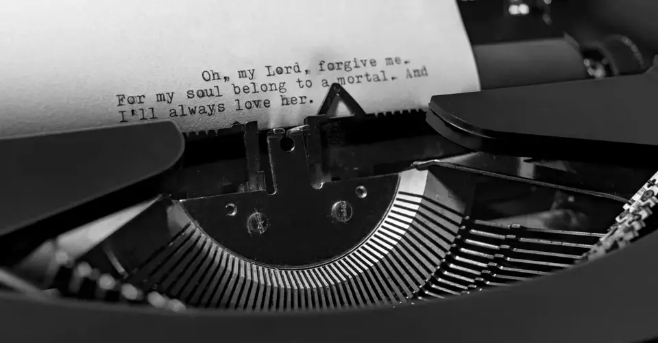 Close-up of a vintage typewriter typing an emotional message on a piece of paper.